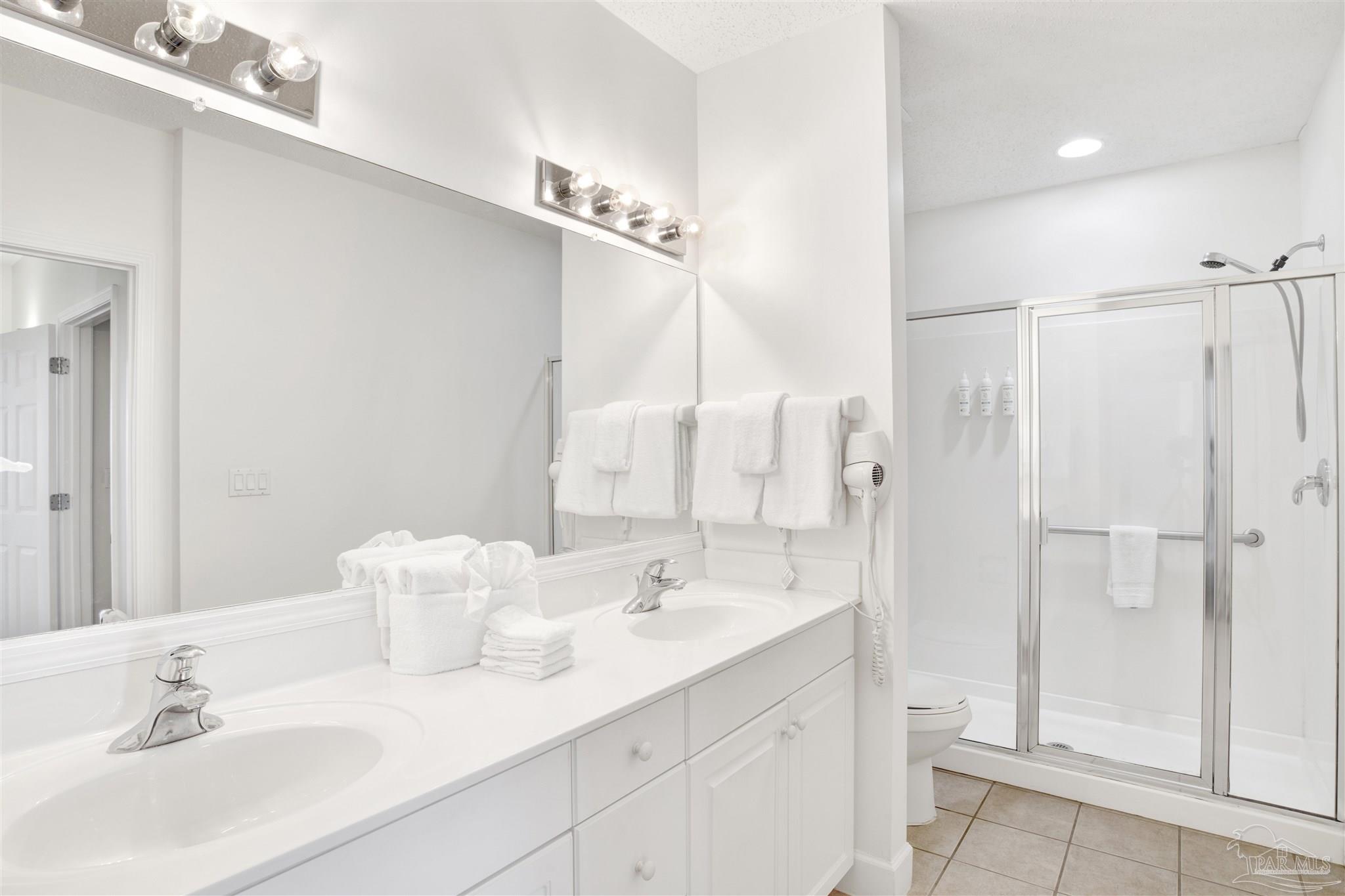 14511 Perdido Key Drive, Unit 408 Perdido Key, FL 32507 - Photo 18 of 43 a bathroom with a sink double vanity and a mirror