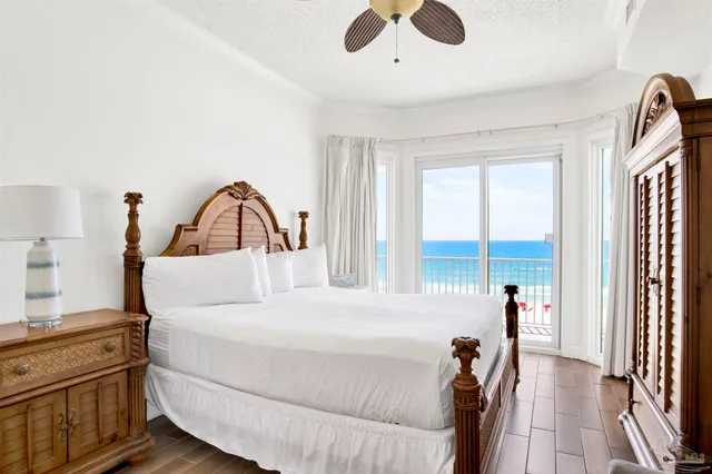 a bedroom with a bed next to a large window with the outer view