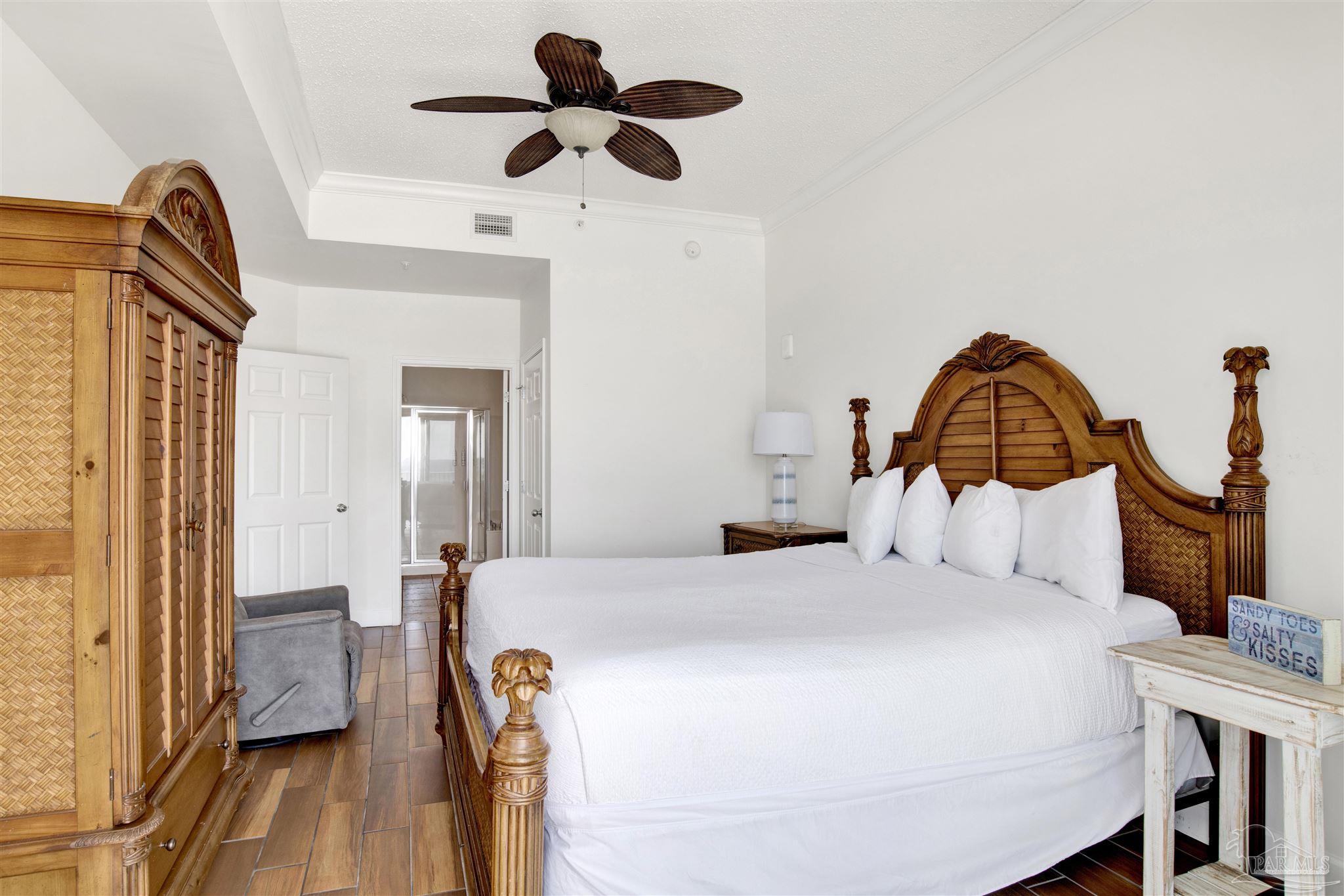 14511 Perdido Key Drive, Unit 408 Perdido Key, FL 32507 - Photo 20 of 43 a bedroom with a bed and a chandelier