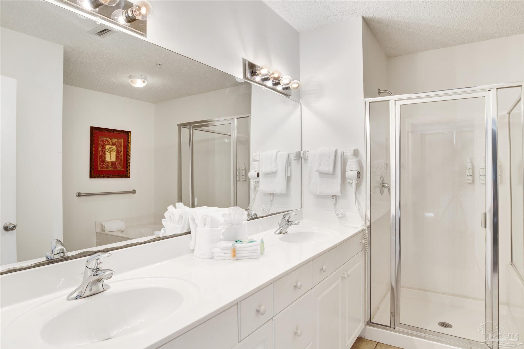 14511 Perdido Key Drive, Unit 408 Perdido Key, FL 32507 - Photo 21 of 43 a bathroom with a double vanity sink mirror and shower