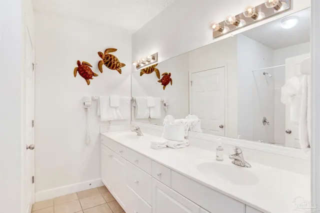 a bathroom with a double vanity sink mirror and
