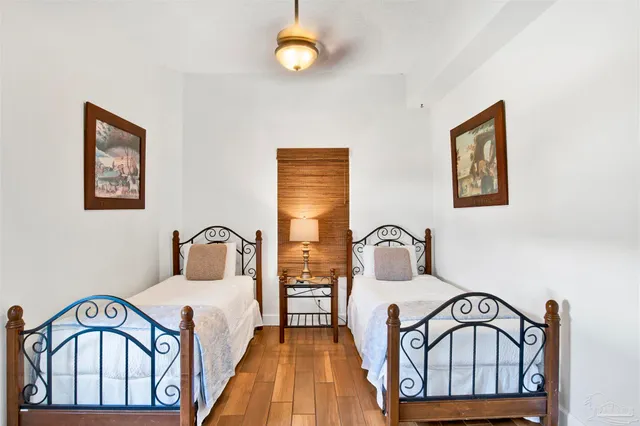 a bedroom with a bed and a large window