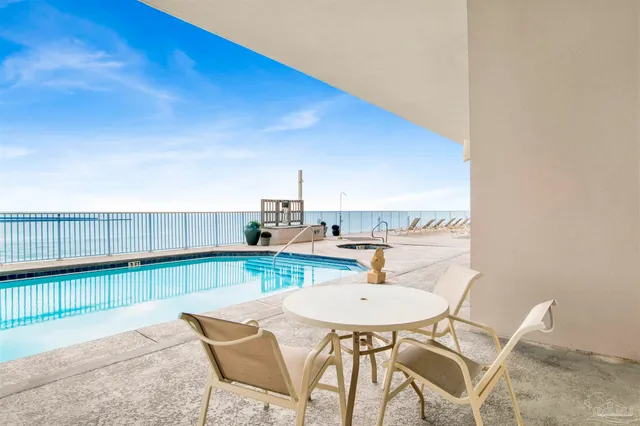a dining room with furniture and a kitchen view