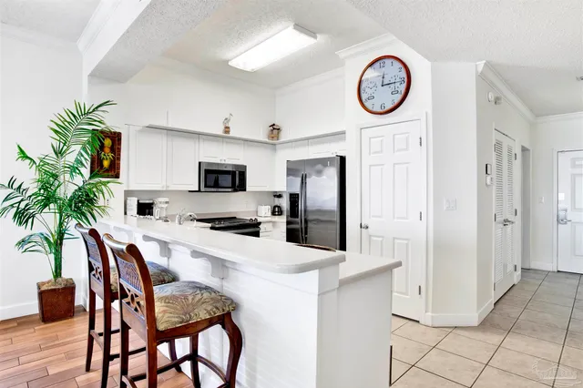 a large kitchen with a table and chairs