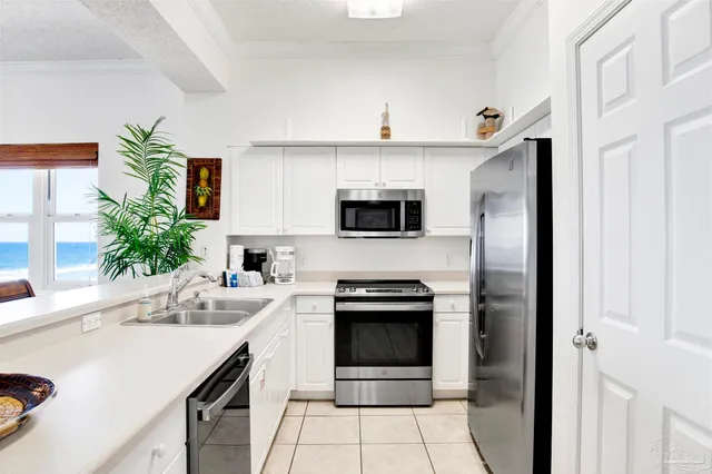 a kitchen with a sink and white stainless steel appliances