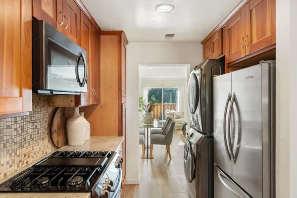 a kitchen with stainless steel appliances granite countertop a refrigerator and a stove