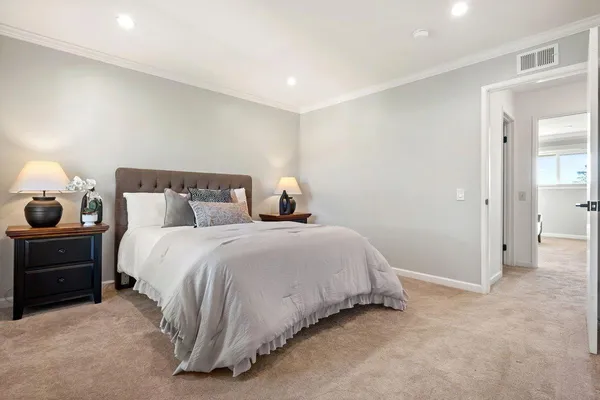 a bedroom with a bed and a lamp