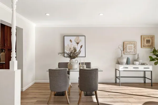 a living room with furniture a flat screen tv and a wooden floor