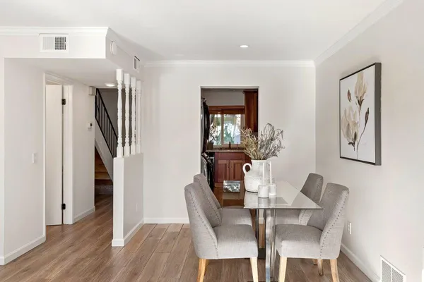 a dining room with furniture and wooden floor