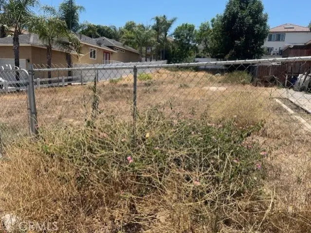 a backyard of a house with lots of green space and plants