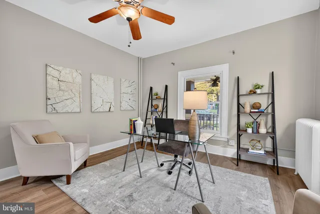 a living room with furniture a rug and a closet