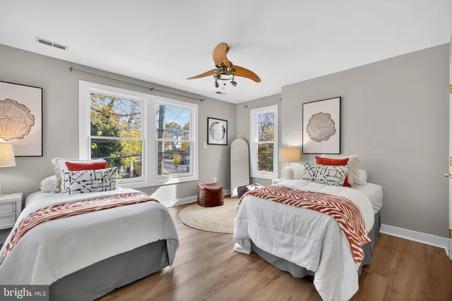 a living room with furniture a clock on wall and a clock