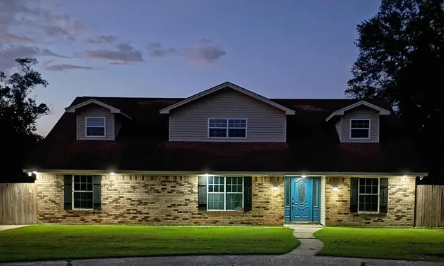a front view of a house with garden