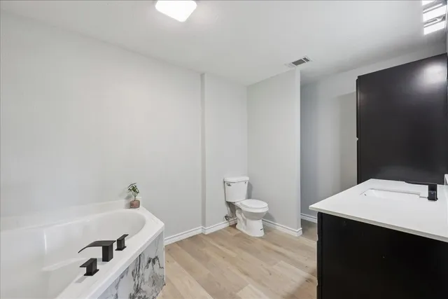 a bathroom with a sink a toilet and bathtub
