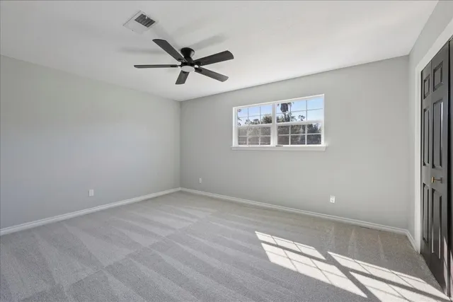 a view of empty room with ceiling fan