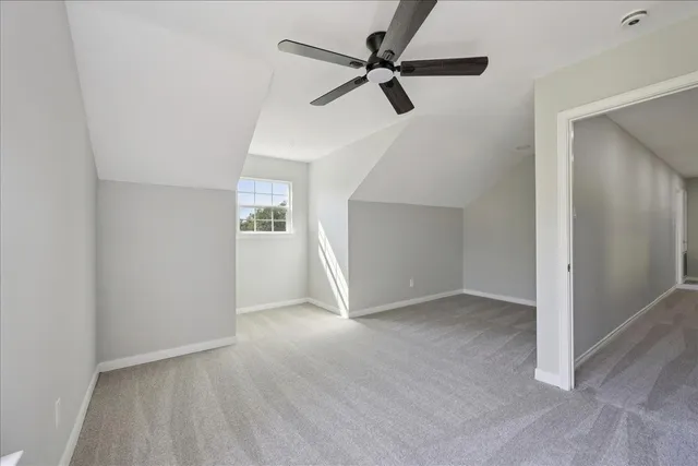 a view of an empty room and a ceiling fan