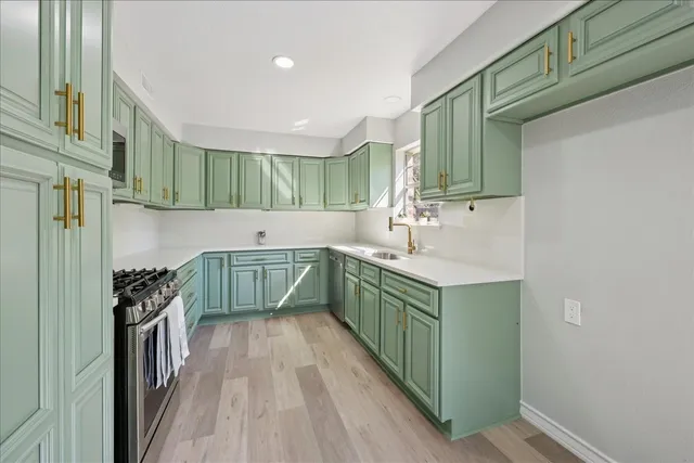 a kitchen with a sink and a stove top oven