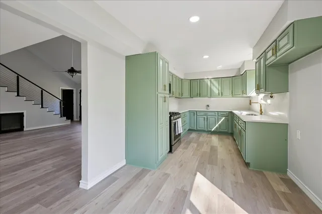 a view of a kitchen with fridge and wooden floor