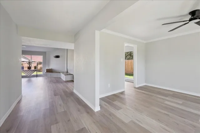 a view of a living room hardwood floor and a kitchen