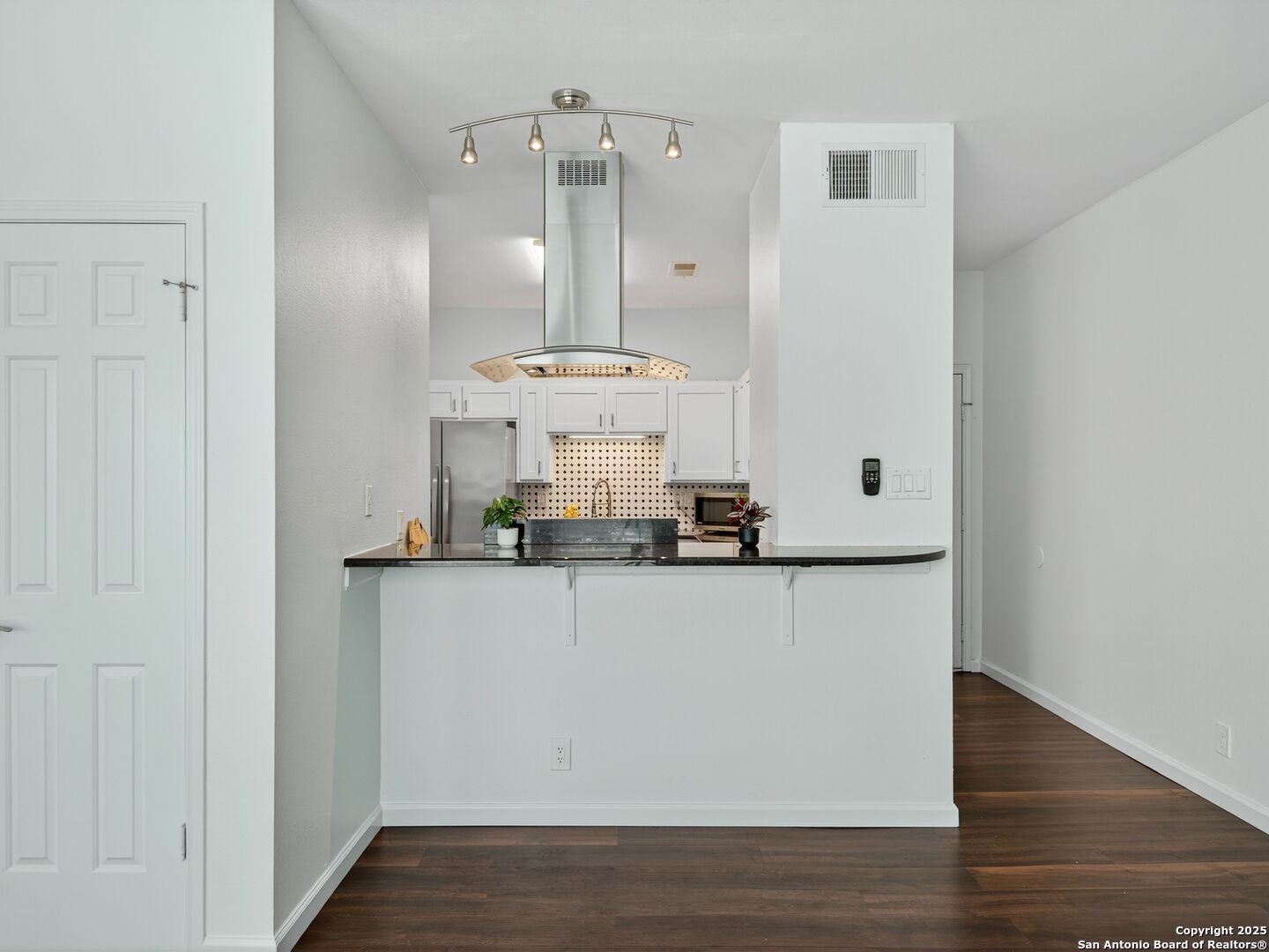 2414 Longview Street, Unit 307 Austin, TX 78705 - Photo 11 of 26 a room with stainless steel appliances a wooden floor