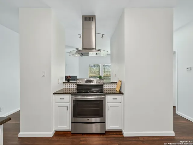 a kitchen with a stove and a microwave