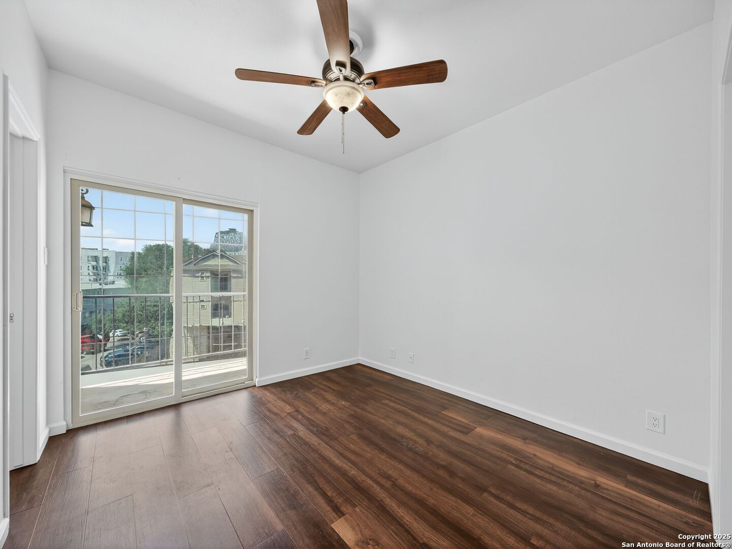 2414 Longview Street, Unit 307 Austin, TX 78705 - Photo 17 of 26 an empty room with wooden floor and windows