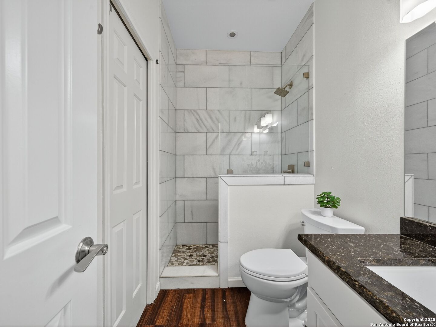 2414 Longview Street, Unit 307 Austin, TX 78705 - Photo 23 of 26 a bathroom with a granite countertop toilet and a sink