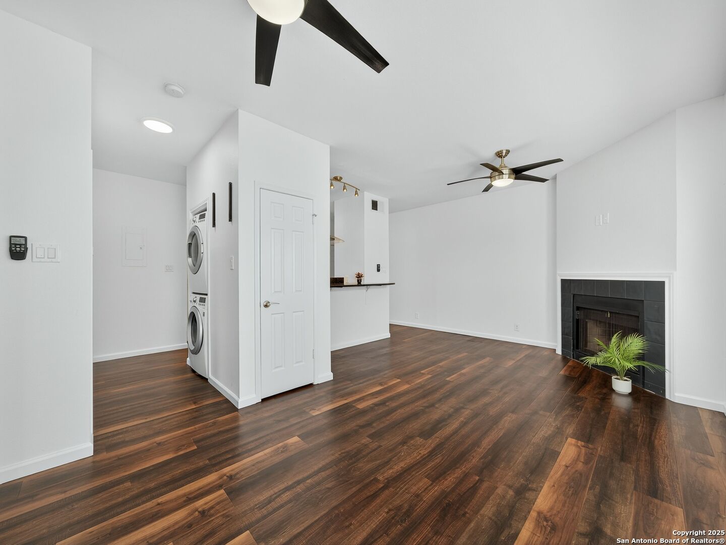 2414 Longview Street, Unit 307 Austin, TX 78705 - Photo 9 of 26 wooden floor in an empty room with a fireplace
