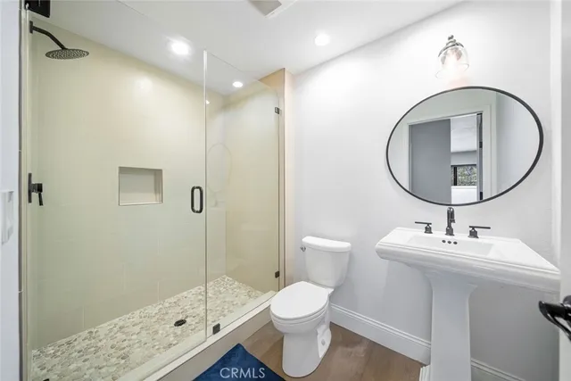 a bathroom with a sink toilet and shower