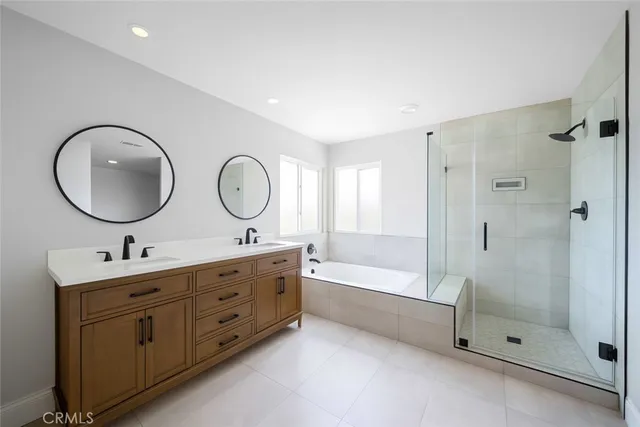 a bathroom with a double vanity sink mirror toilet and shower