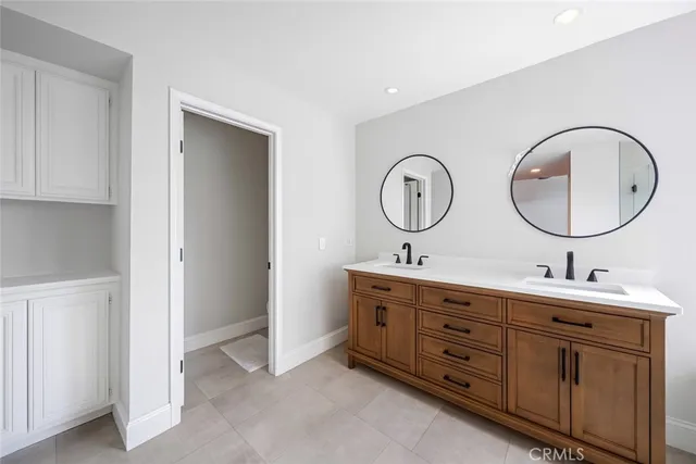 a bathroom with a double vanity sink and a mirror