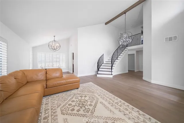 a living room with furniture ceiling fan and a rug