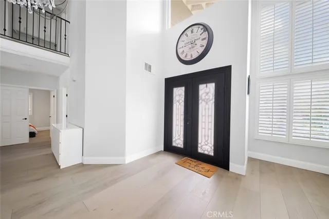 a view of a hallway with wooden floor and a window
