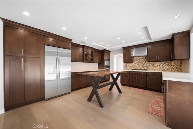 a kitchen with stainless steel appliances kitchen island granite countertop a refrigerator a sink a stove a microwave and island