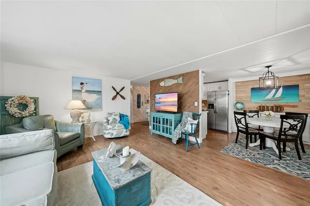 a living room with furniture a couch and a chandelier