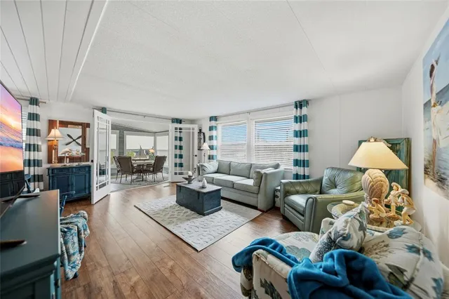 a bedroom with a bed and a flat tv screen on dresser
