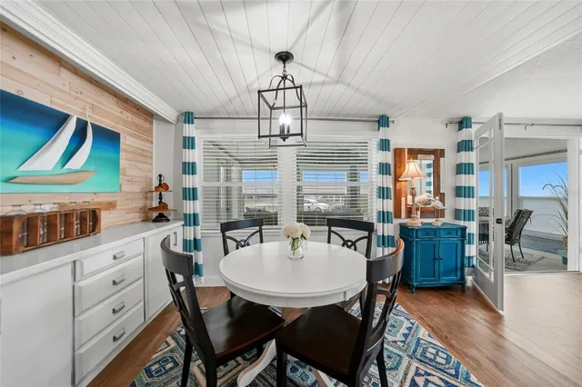 a bedroom with a bed and a flat tv screen on dresser