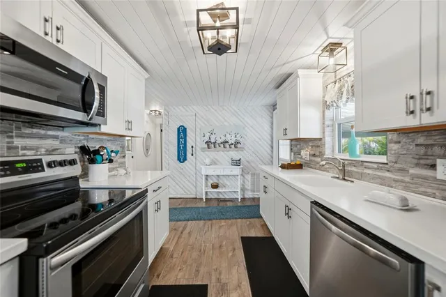 a living room with furniture a clock on wall and a large window