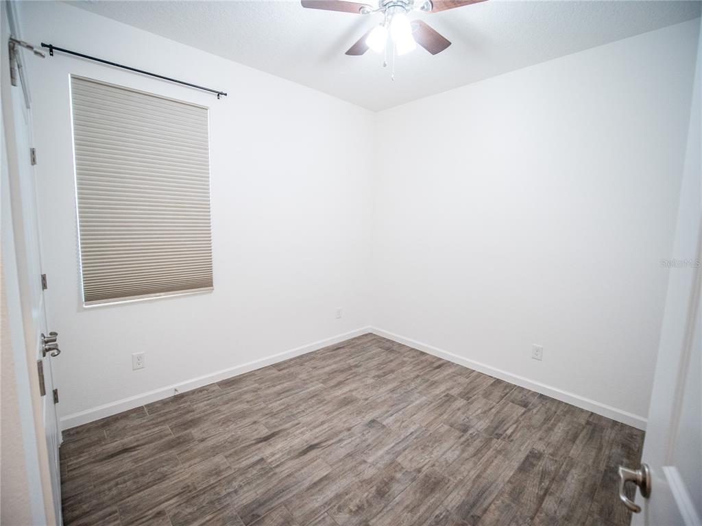 1257 Hendon Loop Davenport, FL 33837 - Photo 12 of 16 an empty room with a chandelier fan