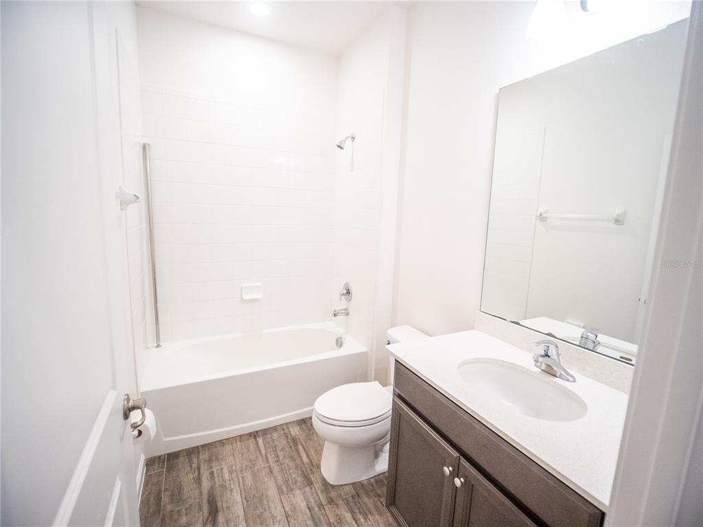 1257 Hendon Loop Davenport, FL 33837 - Photo 13 of 16 a bathroom with a toilet a sink and a bathtub