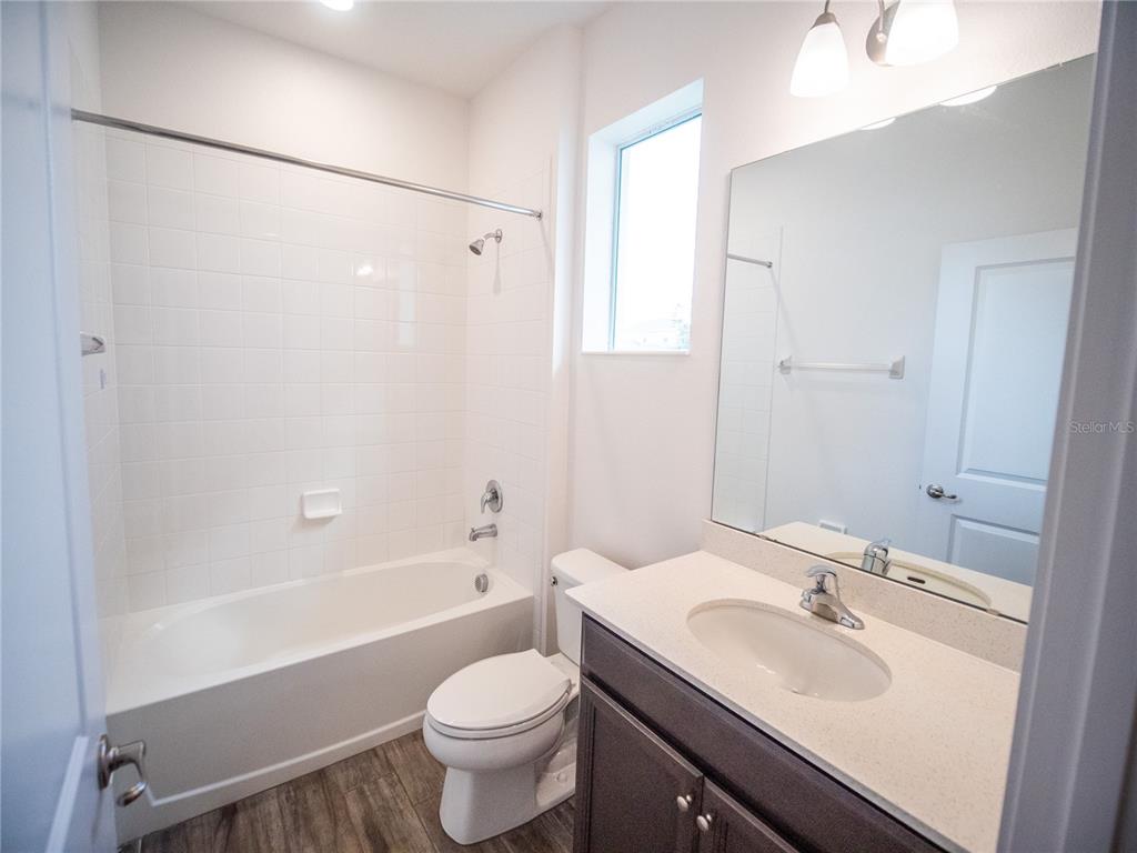 1257 Hendon Loop Davenport, FL 33837 - Photo 15 of 16 a bathroom with a sink toilet and shower