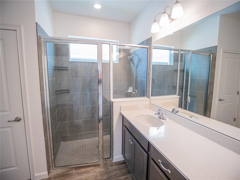 1257 Hendon Loop Davenport, FL 33837 - Photo 6 of 16 a bathroom with a shower sink and mirror