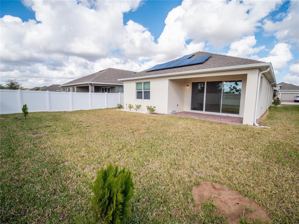 1257 Hendon Loop Davenport, FL 33837 - Photo 9 of 16 a view of a house with a garden and yard