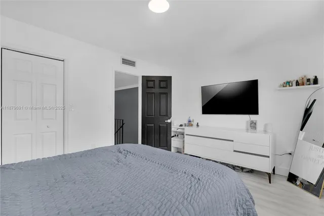 a hotel room with a bed and a flat screen tv