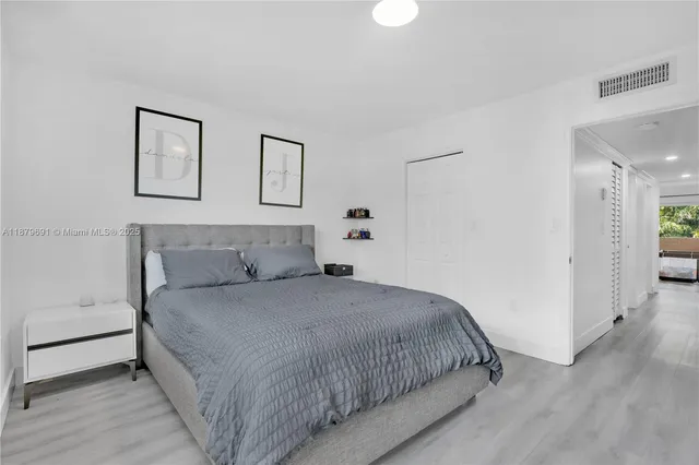 a bedroom with a bed and a couch