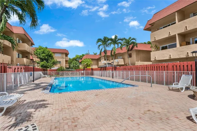a swimming pool with outdoor seating and yard