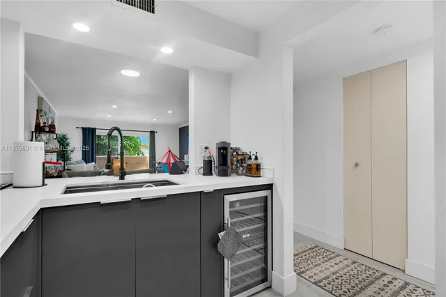 a kitchen with sink and cabinets