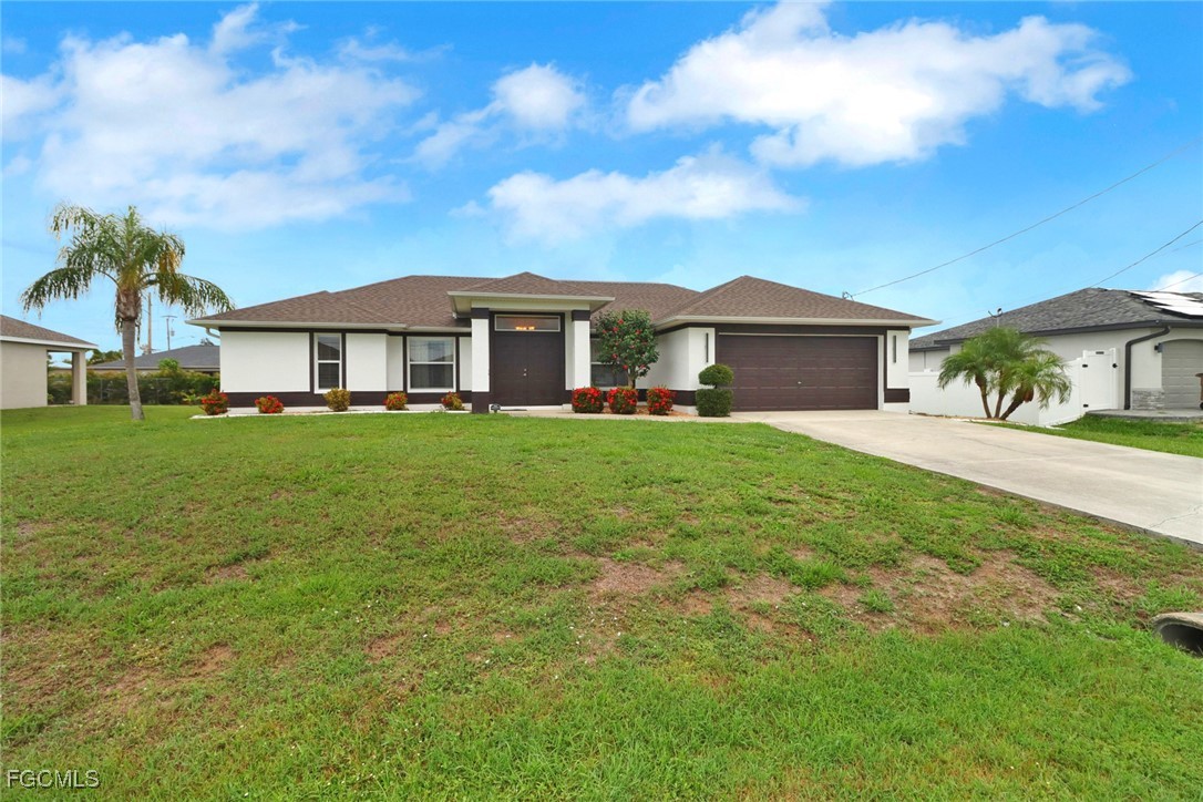 2223 Southwest 16th Terrace Cape Coral, FL 33991 - Photo 3 of 11 a front view of a house with a yard