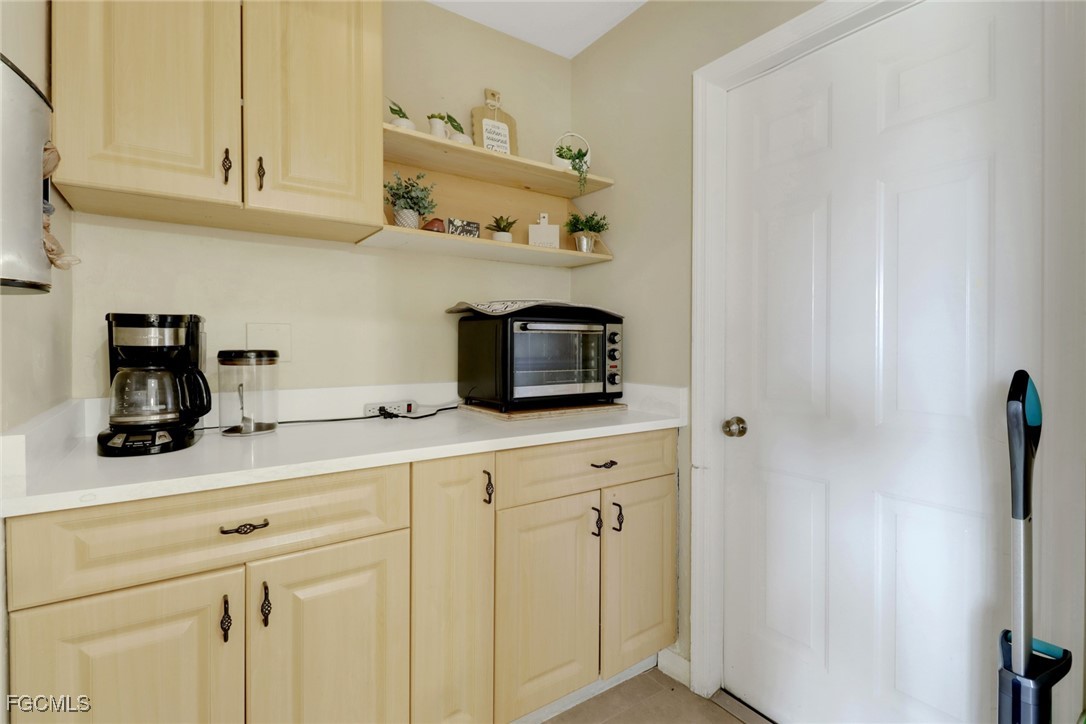 2223 Southwest 16th Terrace Cape Coral, FL 33991 - Photo 6 of 11 a kitchen with cabinets and stainless steel appliances