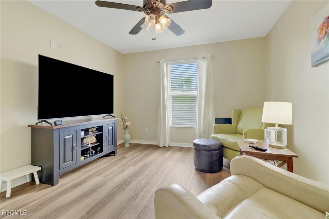 2223 Southwest 16th Terrace Cape Coral, FL 33991 - Photo 7 of 11 a living room with furniture and a flat screen tv